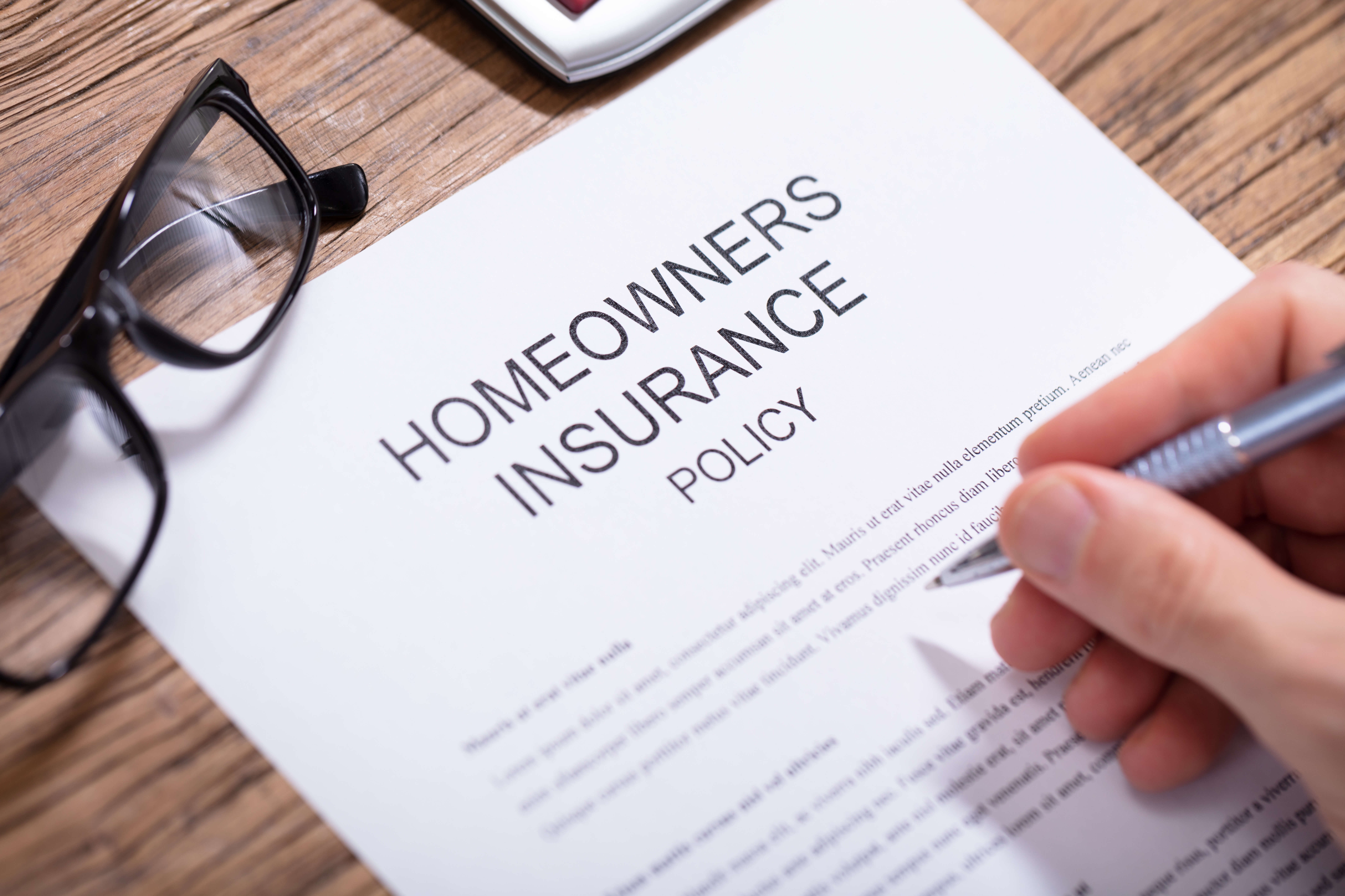 Man signing a homeowners insurance claims.