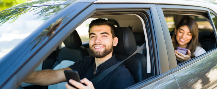 Rideshare driver and female passenger riding while using the gps map